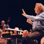 comment-alper-He-often-conducted-concerts-of-his-music-and-sometimes-sang-along-in-his-gruff-distinctive-voice-as-he-conducted-1024×751-1